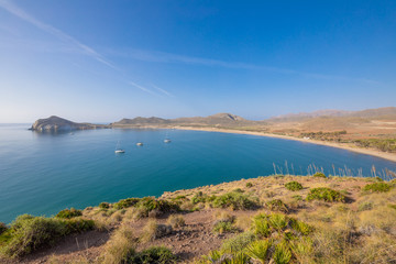 bay of Genoveses and sandy long beach, with yachts and sailboats anchored, from mountain, in Gata Cape Natural Park, in Almeria (Nijar, Andalusia, Spain, Europe) 