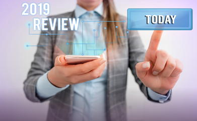 Word writing text 2019 Review. Business photo showcasing New trends and prospects in tourism or services for 2019 Lady front presenting hand blue glow futuristic modern technology tech look