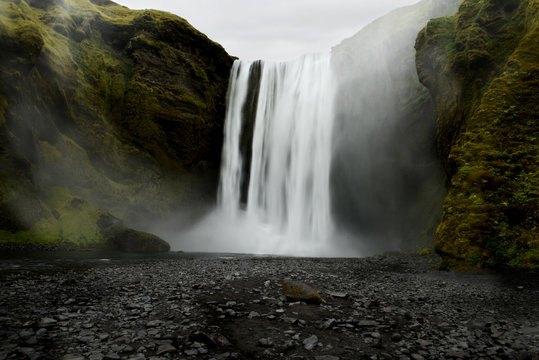 A powerful waterfall among the rocks covered with green moss. Iceland. Dark fabulous atmosphere, vintage. © Ann Stryzhekin