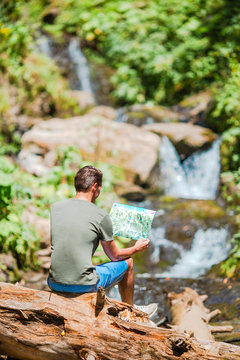Man enjoying view of waterfall in gungle