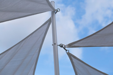 white fabric tensile roof with cloudy sky as background