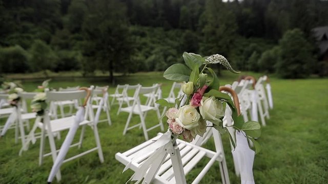 Wedding ceremony. White chairs on the grass