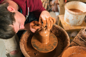 Potter at work. Workshop.
