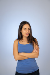 Fototapeta premium Portrait of unsatisfied latin teenager young woman looking worried with concern face