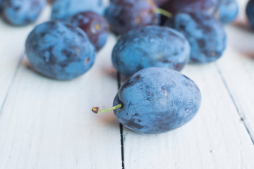 Fresh and delicious plum in front of bunch of other plums