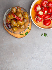 Italian food ingredients background with olives, oil red stuffes with cheese bell peppers