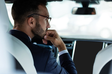 Businessman feeling bored while waiting in the traffic jam