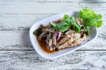 Spicy Minced  Chicken  Salad in white plate on wooden background