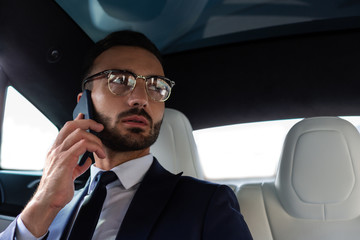 Handsome bearded man wearing suit calling secretary