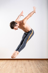 Naklejka premium Beautiful male ballett dancer performing indoor