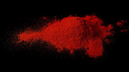 Dry red spicy pepper, paprika powder isolated on black background