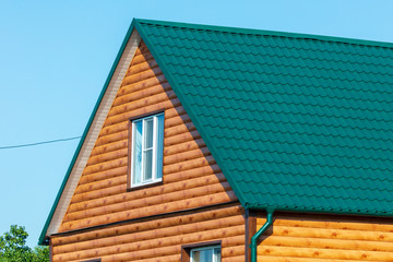 House with green roof tiles