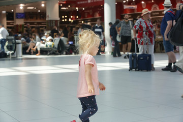 Child lost at the airport or shopping mall, little girl looking for her parents