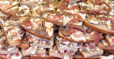 Lard with meat on bread as a background