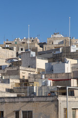 Fototapeta na wymiar Stone buildings in Malta under the clear blue sky