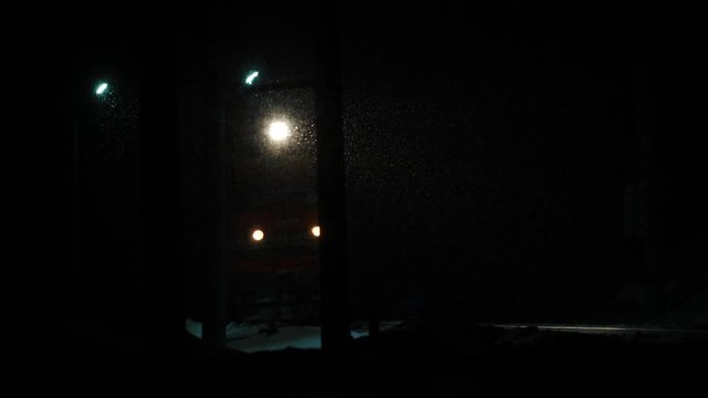 Siberian night train in heavy snow long focus shot