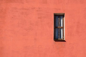 window on the red building of the house in the city