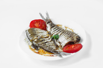 two raw fish on a white plate