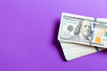 Top view of bundle of 100 dollar bill on colorful backgound. Business concept with copy space