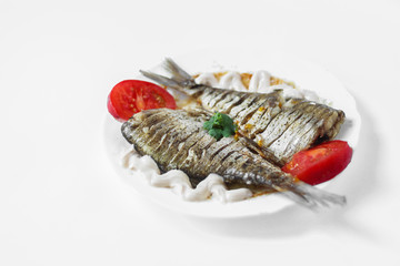 two raw fish on a white plate