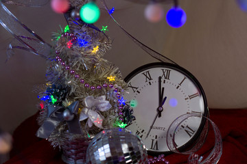 Christmas decorations White little Christmas tree with a clock on a dark background. Background for design. Happy New Year 2020. .