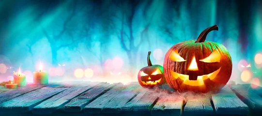 Foto auf Acrylglas Jack O’ Lanterns In Spooky Forest With Ghost Lights - Halloween Background © Romolo Tavani