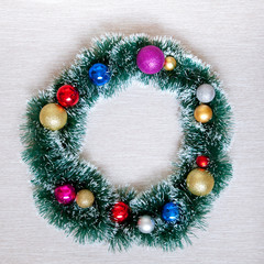 Christmas wreath of tinsel and balls. New Year decorations, top view.