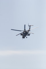 A military helicopter flying in the sky