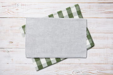 Napkin. Kitchen towel or table cloth on white wooden scene. Mock up for design. Top view.