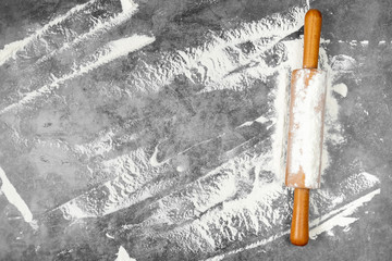 Baking flat lay with rolling pin, flour on gray background. Bake menu, recipe, homemade pastry concept. Top view, with copy space for your text.