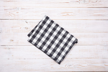 Napkin. Kitchen towel or table cloth on white wooden scene. Mock up for design. Top view.