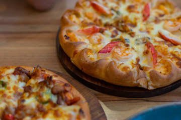 Thai chicken trio pizza on wooden background