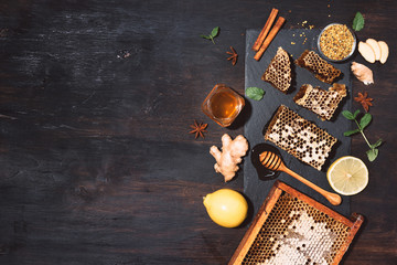 Ingredients for healthy hot drink. Lemon, ginger, mint, honey, apple and spices on black slate tray...