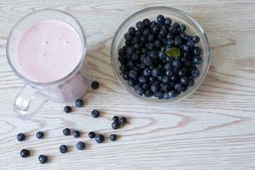 Bowl with fresh blueberries. Yogurt with bilberry. Healthy breakfast, snack, vegetarian food.