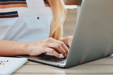 hands typing on laptop