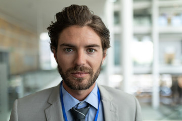 Fototapeta premium Caucasian businessman looking at camera in modern office