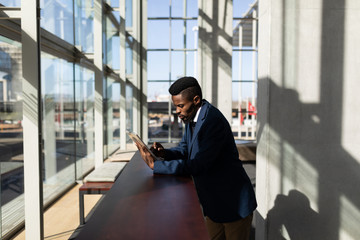 African-American businessman using digital tablet in office