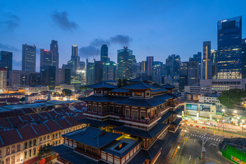 Aerial view of Buddha Tooth Relic Temple in China town, Singapore Downtown skyline. Financial district and business centers in technology smart urban city in Asia. Skyscraper and high-rise buildings. © tampatra