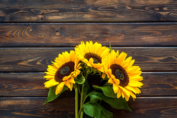 Field flowers design with sunflower bouquet on wooden background top view space for text