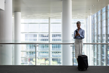 Fototapeta premium Caucasian businesswoman using mobile phone in office