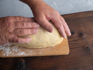 Preparation, kneading dough for pizza, baking. In the frame of natural human hands.