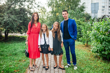 Fototapeta premium Family with two kids back to school