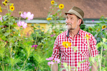 handsome bavarian man in his 50s standing in the garden