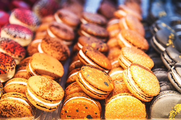 Colored french macaroons in a shop window.