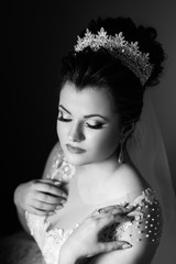 Beauty woman with wedding hairstyle and makeup. Bride fashion. Woman in white dress, perfect skin. Skincare. Sexy bride.  Preparing the bride for the upcoming wedding. Black and white.