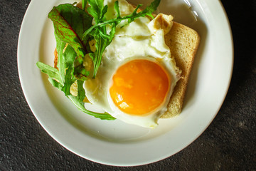 fried eggs with bread or salad leaves - tasty and wholesome food, menu concept. food background. copy space
