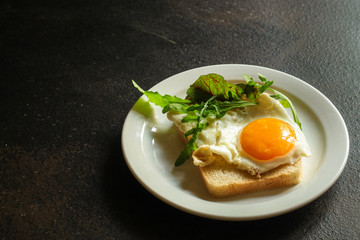 fried eggs with bread or salad leaves - tasty and wholesome food, menu concept. food background. copy space