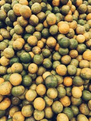 A great amount of green and yellow limes. Vegetarian, vegan, healthy and summer concept. Natural sunny juicy background, pattern and texture. Top view, flat lay.