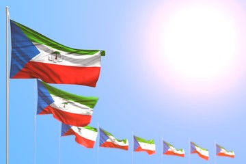 wonderful many Equatorial Guinea flags placed diagonal with bokeh and free space for content - any holiday flag 3d illustration..