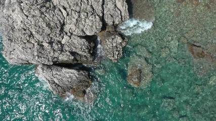Sea waves roll against coastal cliffs